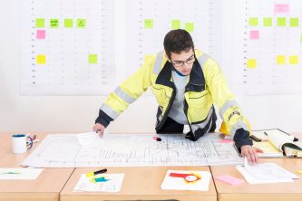 man working on the building plan